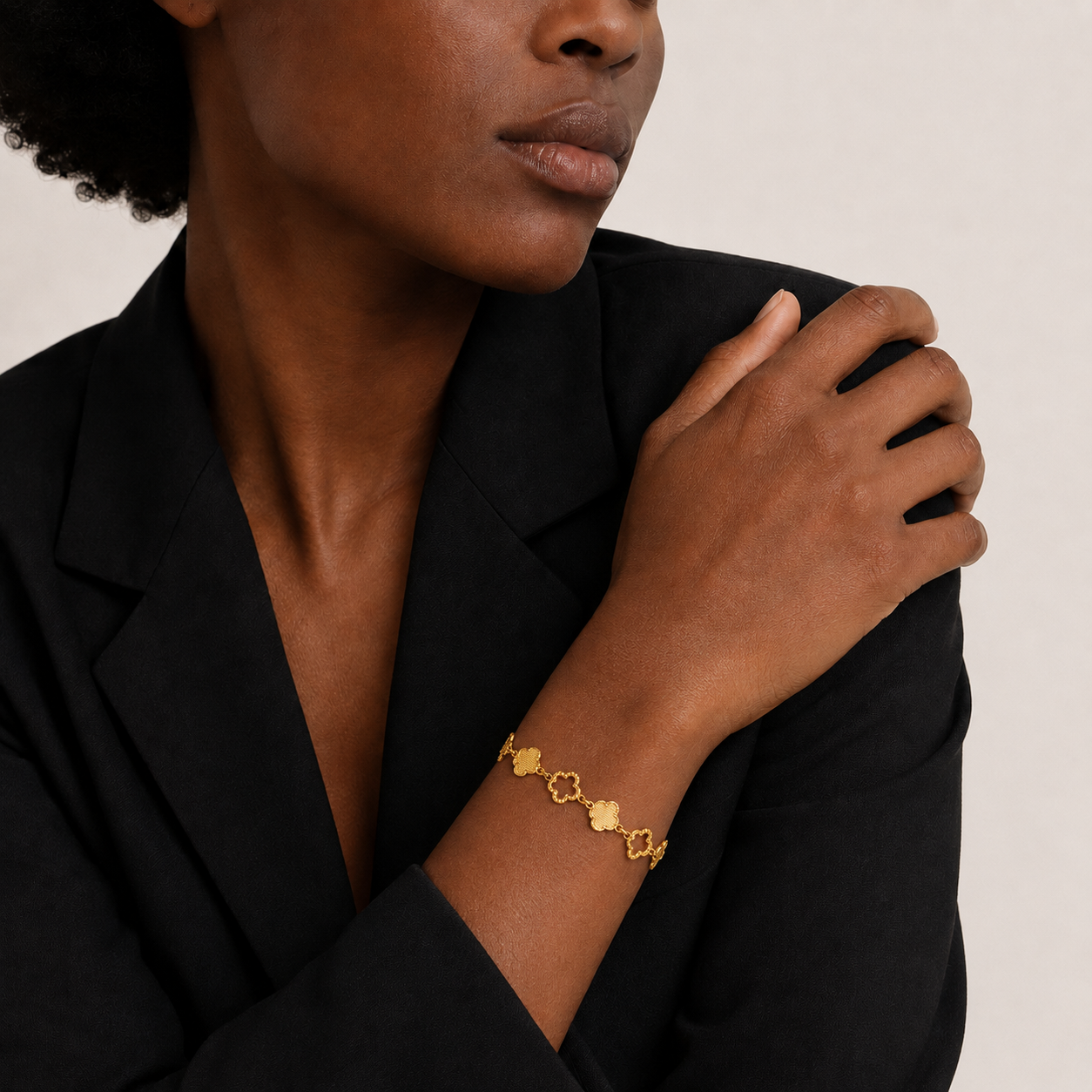 Model wearing MINARIA Gold Clover Station Bracelet
